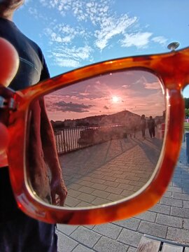 Sunset reflected in sunglasses during an evening walk