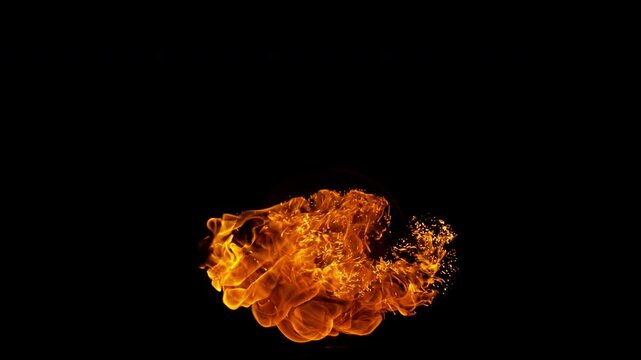 Small fire explosion with glowing sparks and embers isolated on a black background. Dynamic flames and combustion effects captured in high detail for dramatic visual impact.