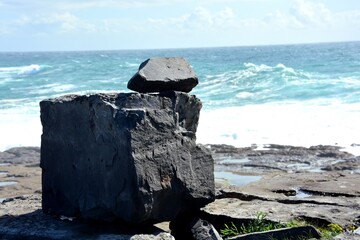 Balanced limestone rock overlooking the Atlantic Ocean on Inishmore, Ireland © Ramona