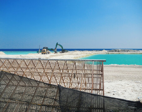 Maldives, Construction machinery working on a coastal development project.