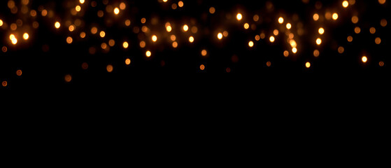 Abstract background with golden bokeh lights on black. Glowing blurred festive string lights border at the top. Dark empty copy space for text and holiday celebration design.  © Russell Edwards 
