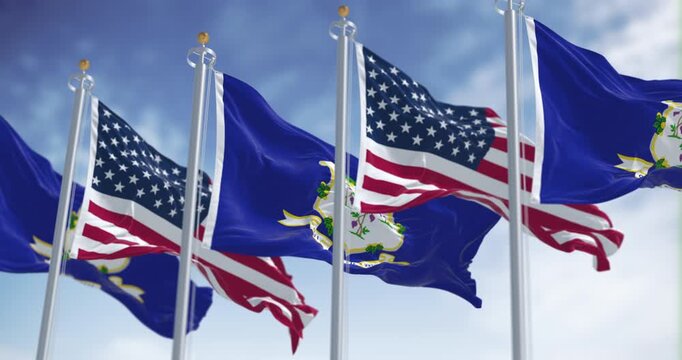 Connecticut state flags waving with national american flags on a clear day.