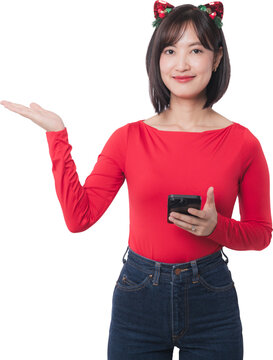 Happy young asian woman wearing headband present christmas sale discount offer holding smartphone for black friday shopping deal over transparency background studio shot