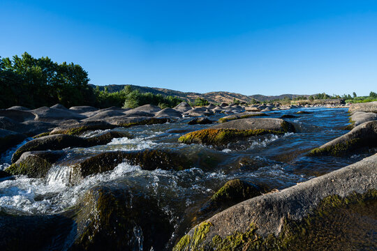 river water flowing over eroded rocks at piedras magicas chile
