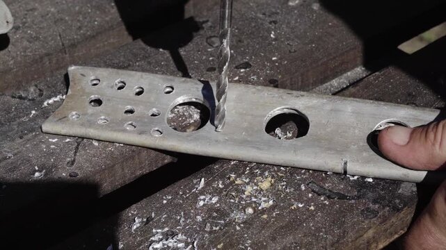 Fabrication of a custom shock-absorption system for an electronic stabilizer and video camera for motorcycle mounting; drilling weight-reduction holes in aluminum parts
