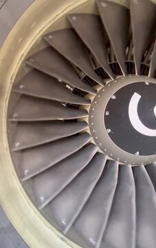 Half jet engine turbine spined on airport.