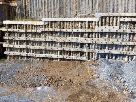 Aerial view of a reinforced concrete retaining wall at a construction site with exposed soil and gravel in Istanbul, Istanbul, Turkiye.