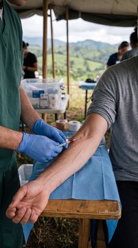 Inserting Intravenous Catheter into Cephalic Vein Outdoors