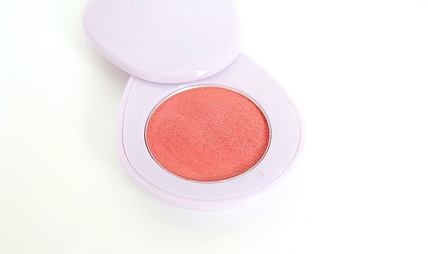 Compact pink powder blush on white background