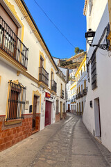 Setenil de las Bodegas is a famous cave house town featuring homes built beneath massive rock overhangs in Cadiz, Andalusia, Spain  © Olga Biliak