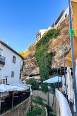 Setenil de las Bodegas is a famous cave house town featuring homes built beneath massive rock overhangs in Cadiz, Andalusia, Spain  © Olga Biliak