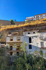Setenil de las Bodegas is a famous cave house town featuring homes built beneath massive rock overhangs in Cadiz, Andalusia, Spain  © Olga Biliak