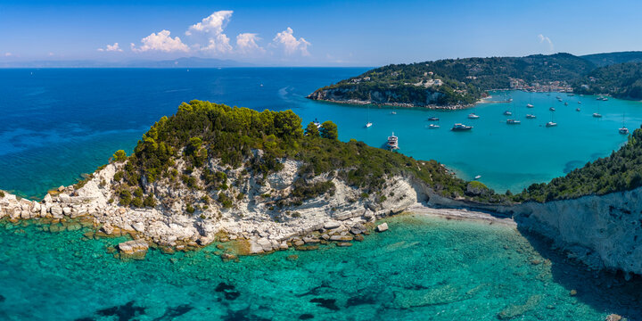 Aerial view of rocky headland and turquoise bay near Lakka, Paxos, Ionian Islands, Greece