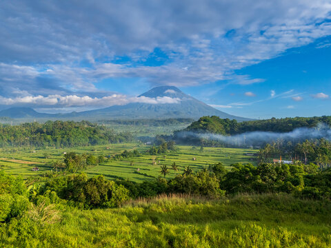 Sideman Valley and Mount Agung volcano, the highest mountain in Bali, with rice terraces, Bali, Indonesia
