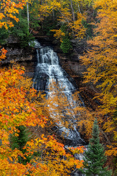 Brilliant Fall color frames Chapel Falls at Pictured Rocks National Lakeshore, Michigan, USA