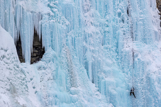 Ice climber on the Weeping Wall icefall in Banff National Park, Alberta, Canada.