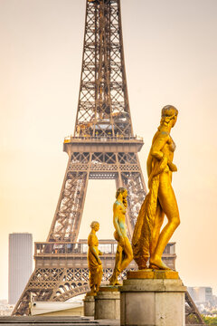 Golden statues on the Trocadero terrace with the Eiffel Tower behind, Paris, France