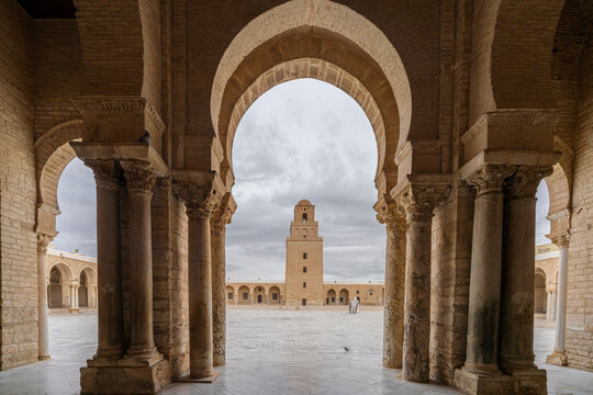 Minaret of the Great Mosque of Kairouan framed by an arched colonnade, Kairouan, Tunisia