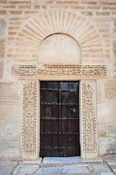 Old wooden doorway with a carved stone frame, Kairouan, Tunisia
