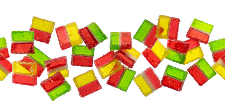 Seamless horizontal pattern of scattered three layered jelly marmalade candies isolated on transparent background. Neon gummy sweets endless border for packaging design.