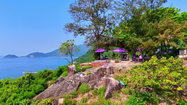 Cinematic 4K drone flight over a railway track leading into a jungle tunnel and opening to the sea in Vietnam. Dense tropical forest and ocean views. Perfect for travel, transport, and documentary con