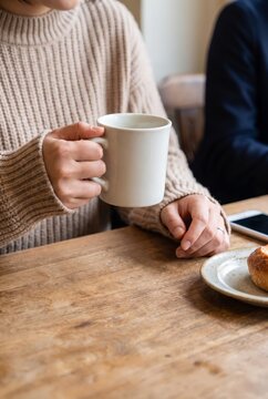 Hands of Japanese woman holding coffee mug