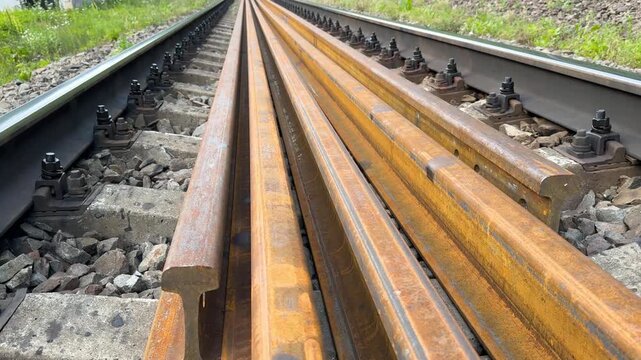 Railway track repair in Ukraine, workers installing continuous welded rails hundreds of meters long, seamless steel lines symbolizing modernization and resilience