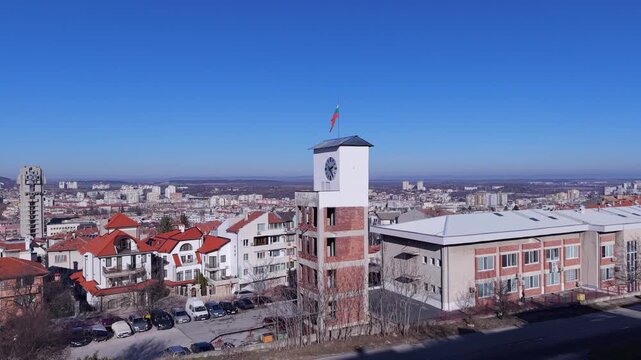 Aerial view of the city of Shumen with its clock tower and the distant Founders of the Bulgarian State Monument in Shumen, Shumen Province, Bulgaria.