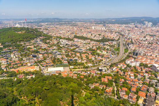 Aerial view of urban landscape featuring highways, residential buildings, and green spaces in a bustling city environment in Istanbul, Turkey 