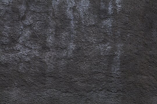 Dark grunge wall texture. Dark rough surface stucco background. Photo background texture.