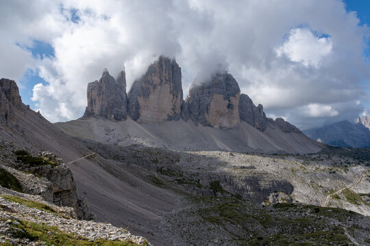Tre Cime di Lavaredo towers emerging from clouds, Dolomites