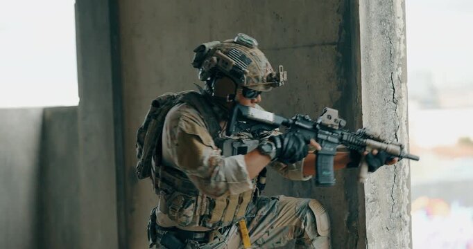Military tactical operator moves between concrete pillars above city during urban operation