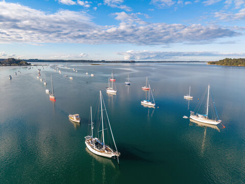 Yachts moored in the calm waters of a harbor channel. Omokoroa, Bay of Plenty, New Zealand