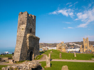Aberystwyth Castle with a scenic sea view, on a sunny day. The castle features a historic design with multiple turrets and battlements, standing tall the town. © Steven F Granville