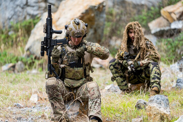 Fototapeta premium Soldiers engaged in tactical training in a mountainous forest area