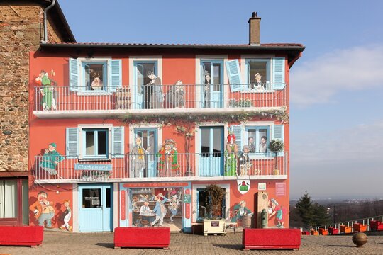Vaux en Beaujolais, France - February 15, 2017: The trompe-l'&oelig;il mural dedicated to Clochemerle located on the facade of the tourist information office in Vaux-en-Beaujolais, France
