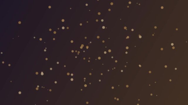 Amber granular particles floating in dark background