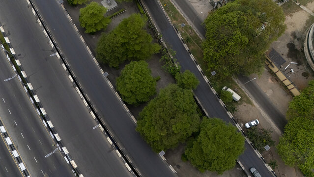 Aerial view of Lagos Island featuring a multi-lane highway bridge surrounded by lush green trees and urban infrastructure Lagos, Lagos, Nigeria.