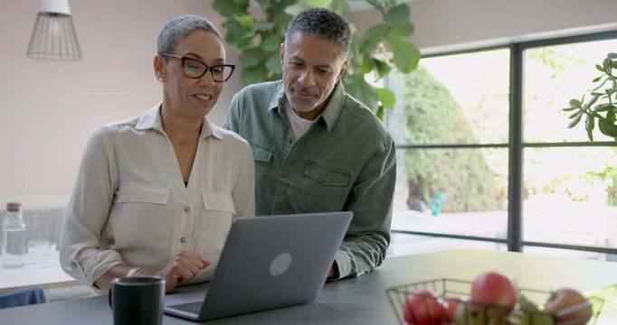 Senior Couple Collaborating on a Laptop