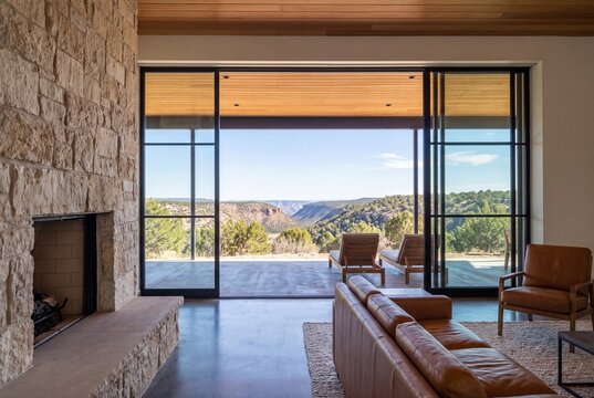 Living Room Glass Sliders Open to Covered Porch and Juniper Hills