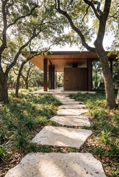 Limestone Path Through Oak Grove to Glowing Glass Pavilion Entrance