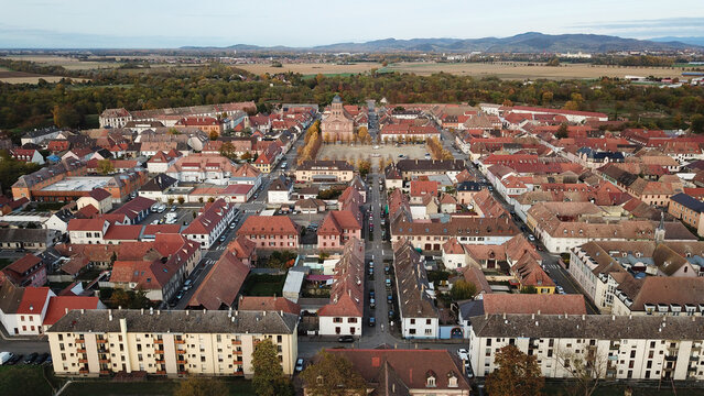 Aerial view of the Vauban walled city, featuring its characteristic grid layout, historic red-tiled rooftops, and central square in Neuf-Brisach, Grand Est, France.