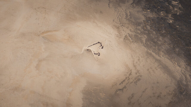 Aerial view of the desert landscape with intricate sand patterns and rocky formations in Denham, Western Australia, Australia.