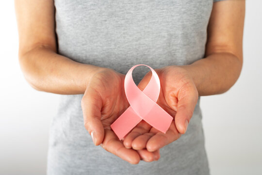 Middle Age Caucasian Woman Holding Pink Ribbon for Breast Cancer Awareness