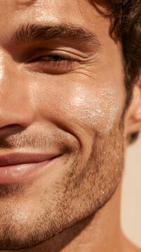 Half face close up of man soft smiling cheek with beard and warm sunlight, revealing skin texture and natural facial detail