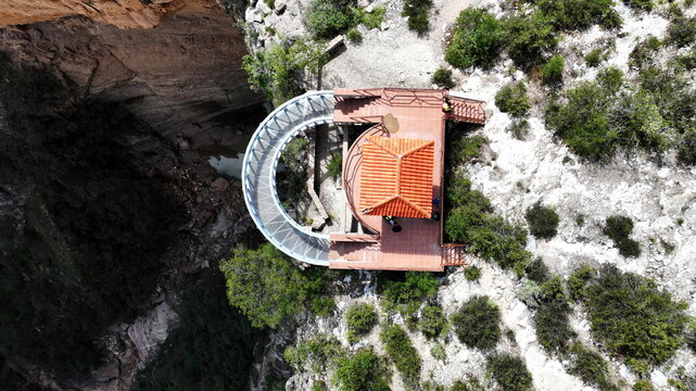 Aerial view of El Vergel waterfall observation deck with a curved walkway and red tiled roof situated on the edge of a deep canyon Torotoro, Potosi Department, Bolivia.
