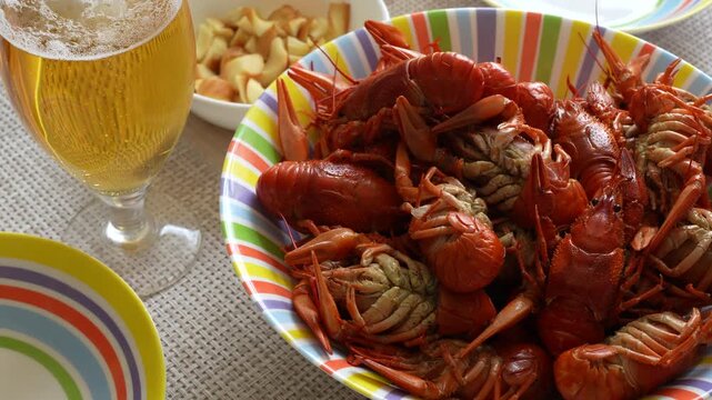 4K footage of freshly boiled red crayfish bowl and glass of cold beer, beer snacks for game day