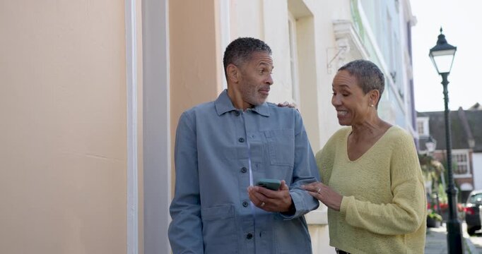 Senior Couple Enjoying a Day Out Together and Looking at Phone for Directions