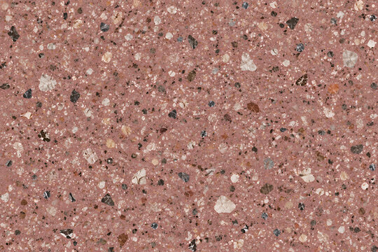 Seamless terracotta pink terrazzo texture background with white, brown, and black marble chips for modern interior design.