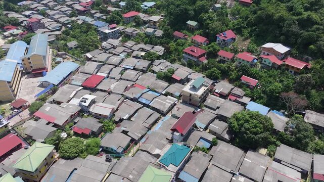 Aerial view of the dense residential area with colorful rooftops nestled among lush greenery on the Perhentian Islands, Terengganu, Malaysia.